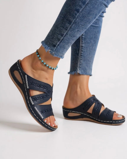 Navy embroidered strappy sandals with cutout details and whipstitching