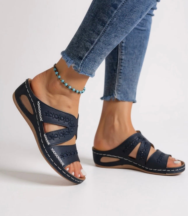 Navy embroidered strappy sandals with cutout details and whipstitching