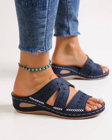 Navy embroidered slide sandals with multi-strap design and perforated details