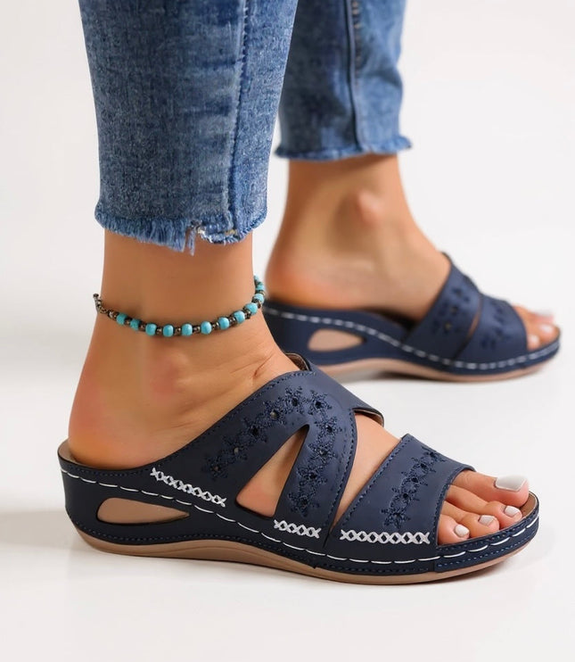 Navy embroidered slide sandals with multi-strap design and perforated details