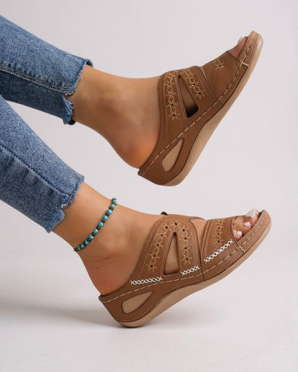 Tan embroidered sandals side view showing wedge sole and strap construction