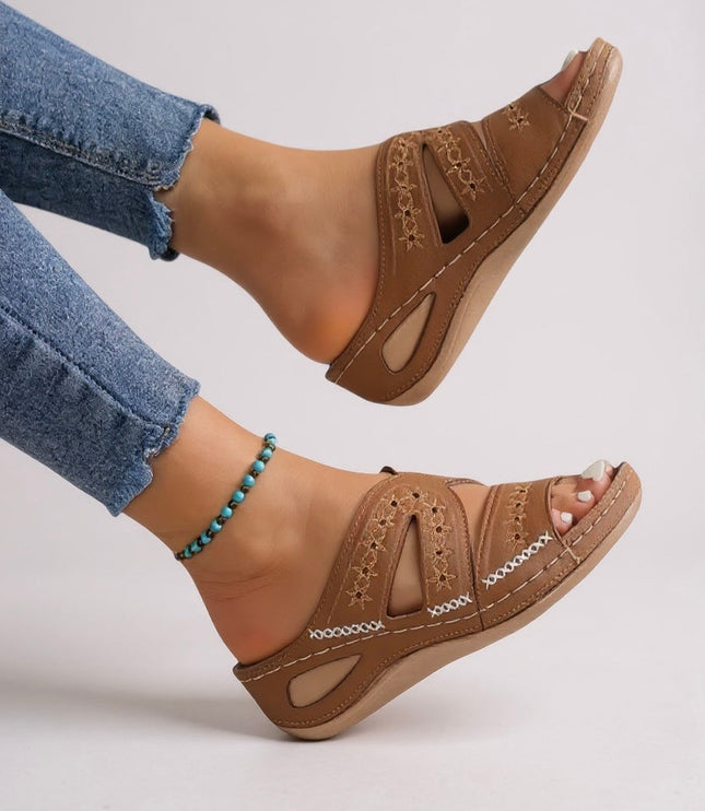 Tan embroidered sandals side view showing wedge sole and strap construction