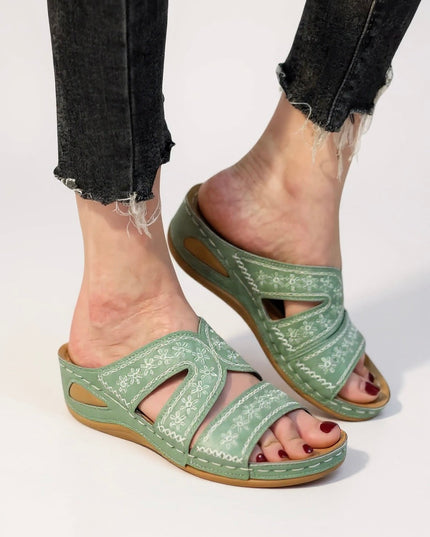 Sage green embroidered strappy sandals with floral stitching and cutout details
