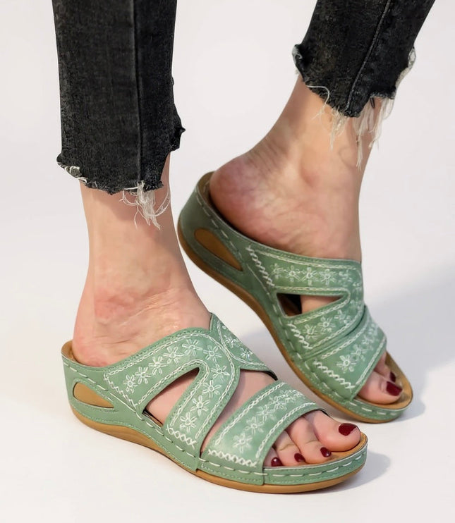 Sage green embroidered strappy sandals with floral stitching and cutout details
