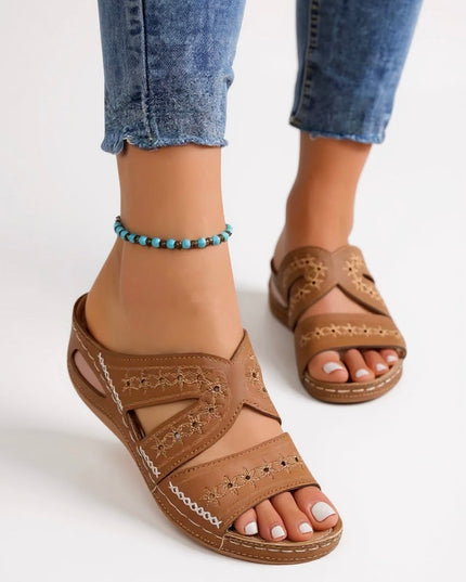 Tan embroidered strappy slide sandals with cross-strap design and stitched details