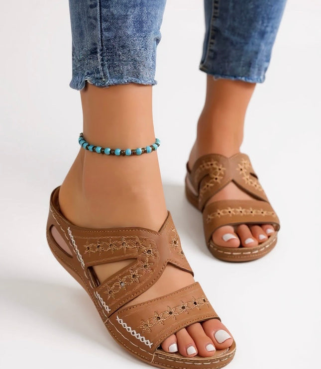 Tan embroidered strappy slide sandals with cross-strap design and stitched details