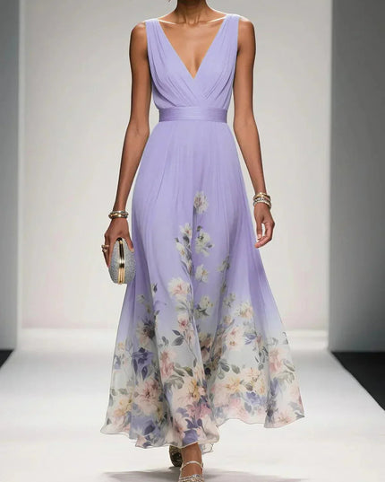 Lavender floral print v-neck sleeveless maxi dress with a delicate floral design along the hem, paired with a clutch.