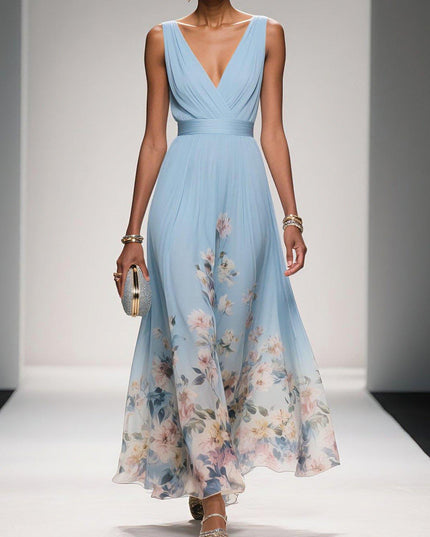 Light blue floral print v-neck sleeveless maxi dress with a pleated bodice and flowing skirt, worn with a silver clutch.