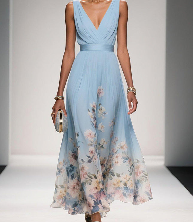 Light blue floral print v-neck sleeveless maxi dress with a pleated bodice and flowing skirt, worn with a silver clutch.