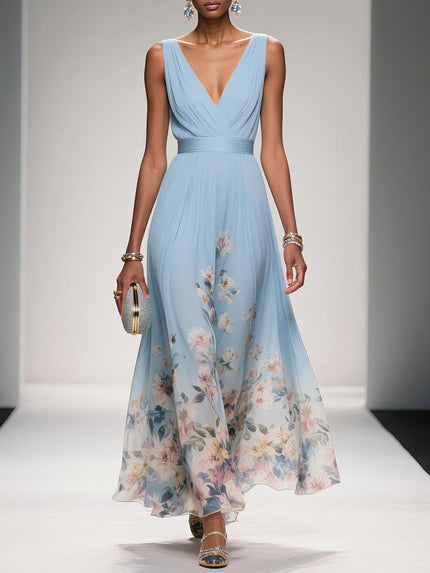 Light blue floral print v-neck sleeveless maxi dress with a pleated bodice and flowing skirt, worn with a silver clutch.