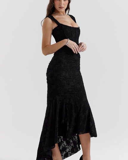 Black floral corset midi dress with ruched details and asymmetric hem, paired with black heels.