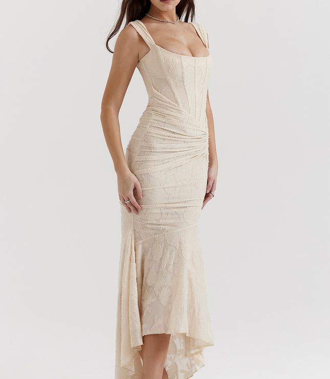 Side profile of a cream floral corset midi dress featuring an asymmetric hem and delicate texture.