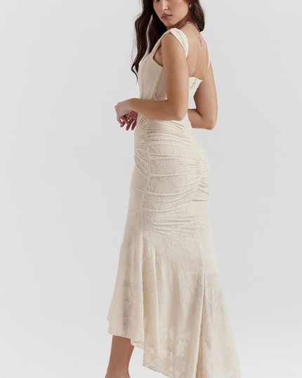 Back view of a cream floral corset midi dress showing the ruched detailing and flowing high-low skirt.