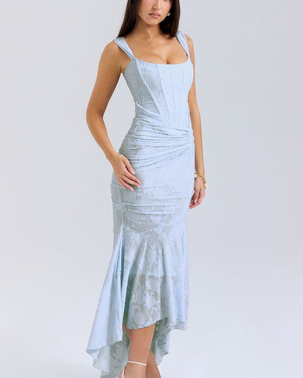 Three-quarter view of the light blue women's floral midi dress, featuring a structured corset top and a flowing asymmetric skirt.