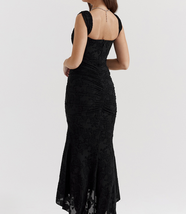 Back view of the black floral corset midi dress, showcasing the ruched detail on the back and the elegant asymmetric hem.