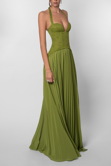 Side profile of a women's green halter floral lace pleated maxi dress, showcasing the full length and flowing skirt.