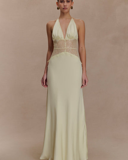 Pale yellow halter neck maxi dress with a deep V-neck and matching yellow lace detail on the bodice, front view.