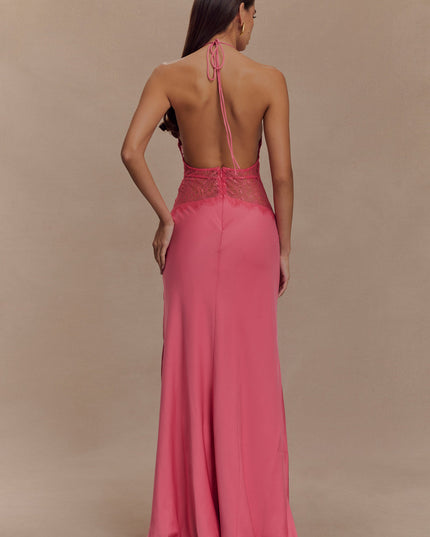 Back view of a women's pink halter neck maxi dress with an open back and intricate lace on the bodice.