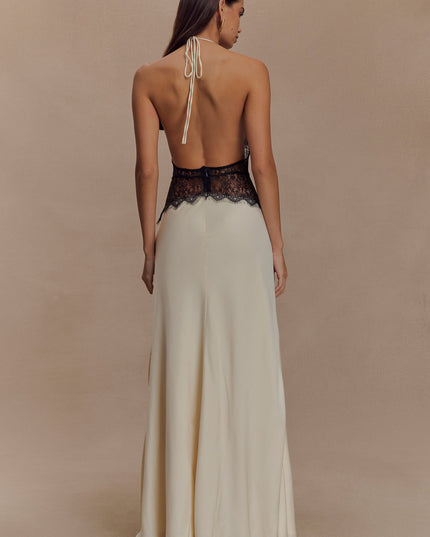 Back view of cream halter neck maxi dress with black lace detail, showing open back and tie closure.