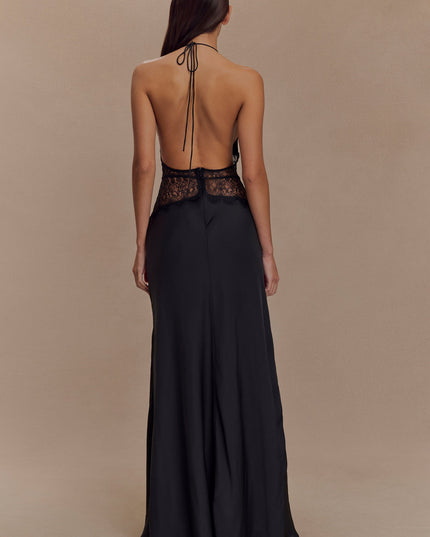 Rear view of a black halter neck maxi dress, showcasing the open back and delicate lace trim.
