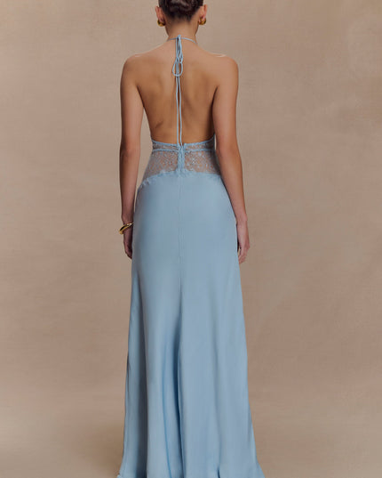 Back view of a light blue halter neck maxi dress, showing the open back design and lace accents.