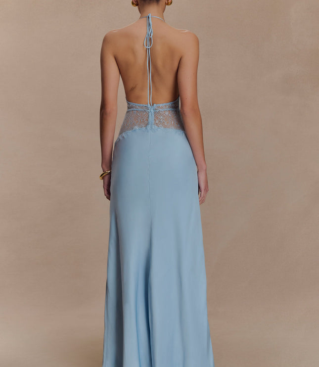 Back view of a light blue halter neck maxi dress, showing the open back design and lace accents.