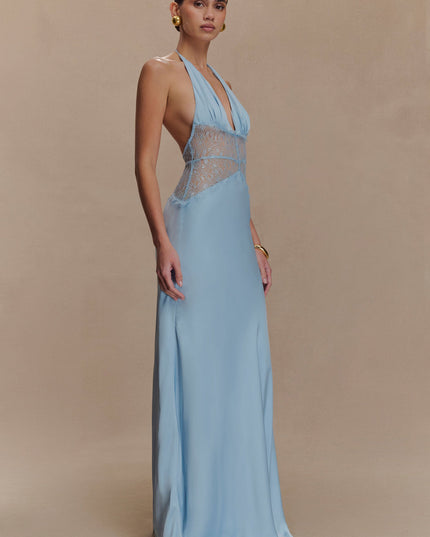 Side profile of a light blue halter neck maxi dress, featuring a fitted bodice with lace and a flowing skirt.