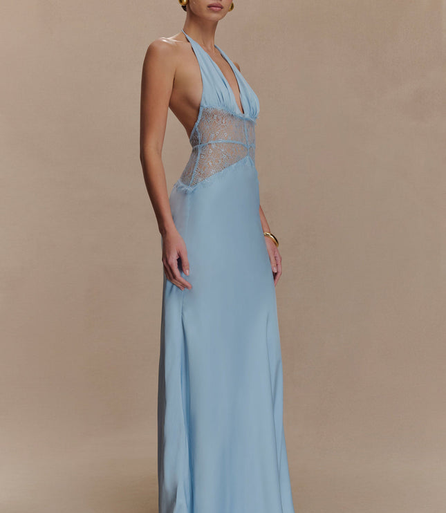 Side profile of a light blue halter neck maxi dress, featuring a fitted bodice with lace and a flowing skirt.
