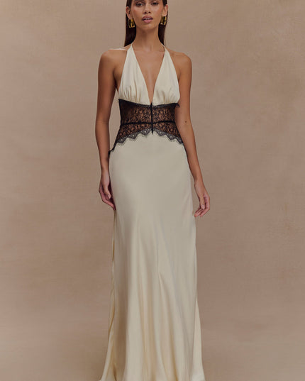 Cream halter neck maxi dress with deep V-neckline and black lace paneling at the waist, front view.