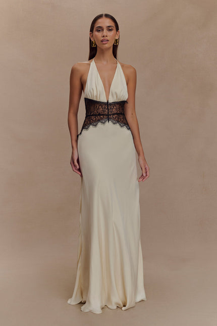 Cream halter neck maxi dress with deep V-neckline and black lace paneling at the waist, front view.