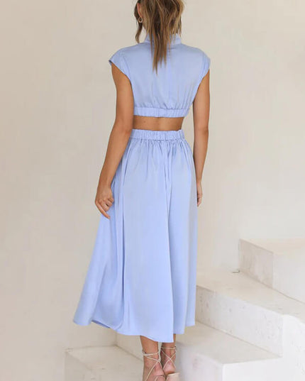 Rear view of a light blue high neck cut out pleated midi dress, showing the gathered skirt.