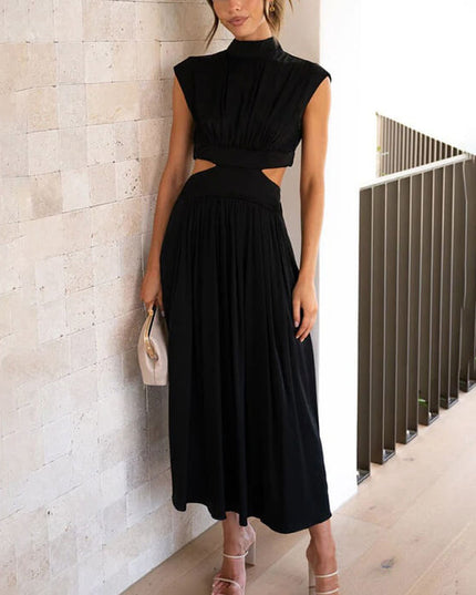 Black high neck cut out pleated midi dress with cap sleeves, paired with an off-white clutch.