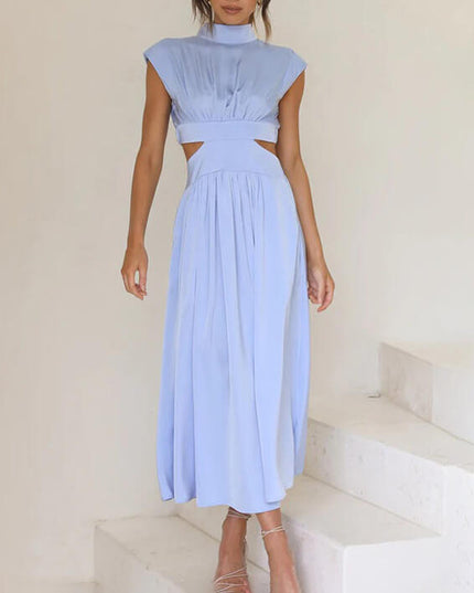 Light blue high neck pleated midi dress with side cut-outs and cap sleeves, on white stairs.
