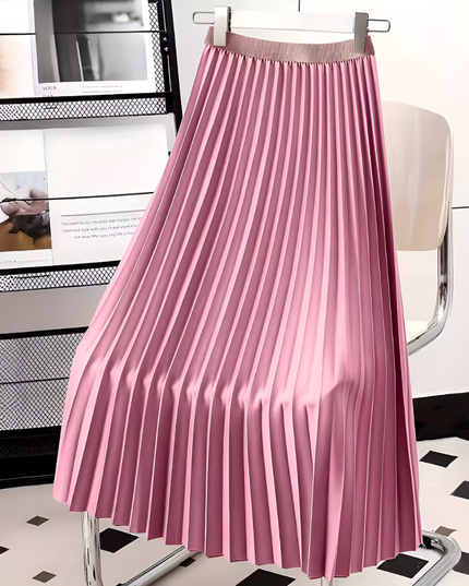 Vibrant pink high waisted pleated satin midi skirt, hanging on a hanger in a studio setting.