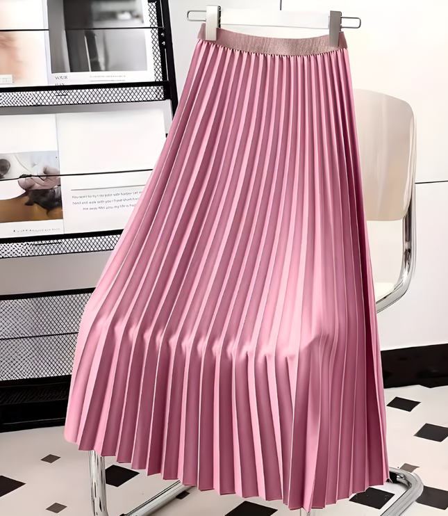 Vibrant pink high waisted pleated satin midi skirt, hanging on a hanger in a studio setting.