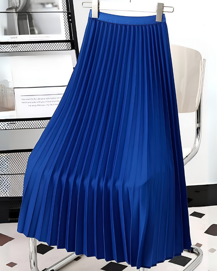 Bright blue high waisted pleated satin midi skirt, displayed on a hanger against a modern backdrop.