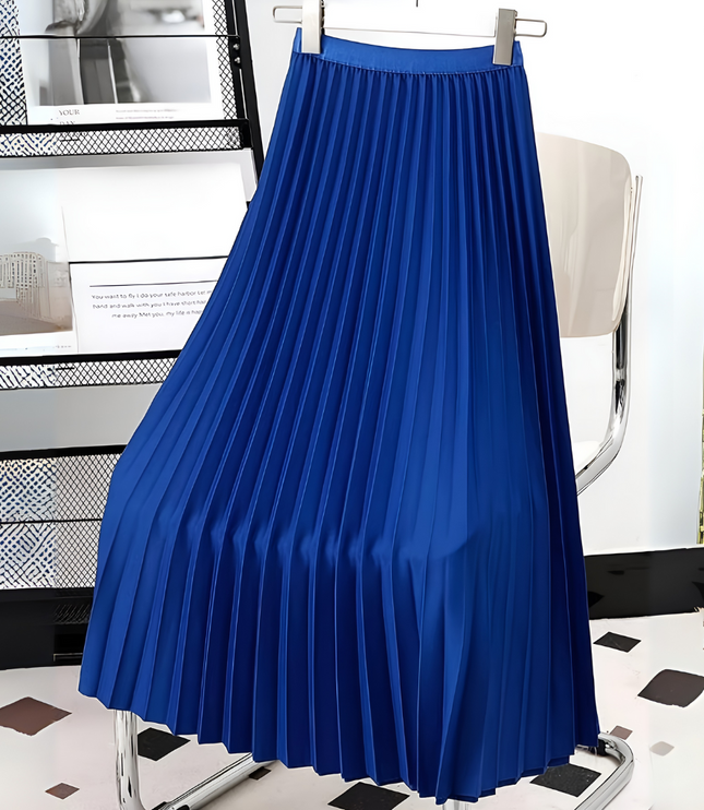 Bright blue high waisted pleated satin midi skirt, displayed on a hanger against a modern backdrop.