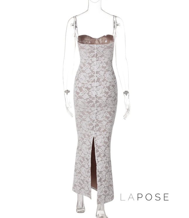 Back view of a white lace backless spaghetti strap midi dress with a subtle slit at the hem.