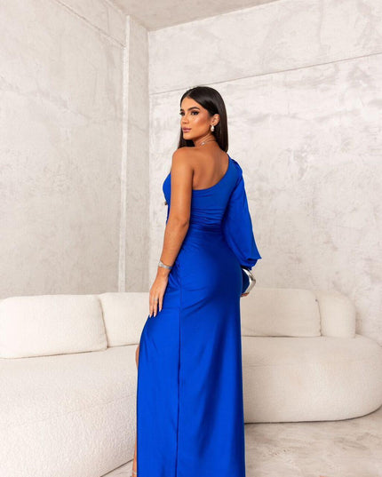 Back view of a women's royal blue one-shoulder maxi dress, showing the sleek design and long skirt