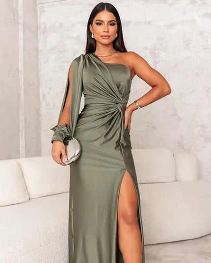 Front view of an olive green one shoulder ruched maxi dress, highlighting the high slit and flowing long sleeve detail.
