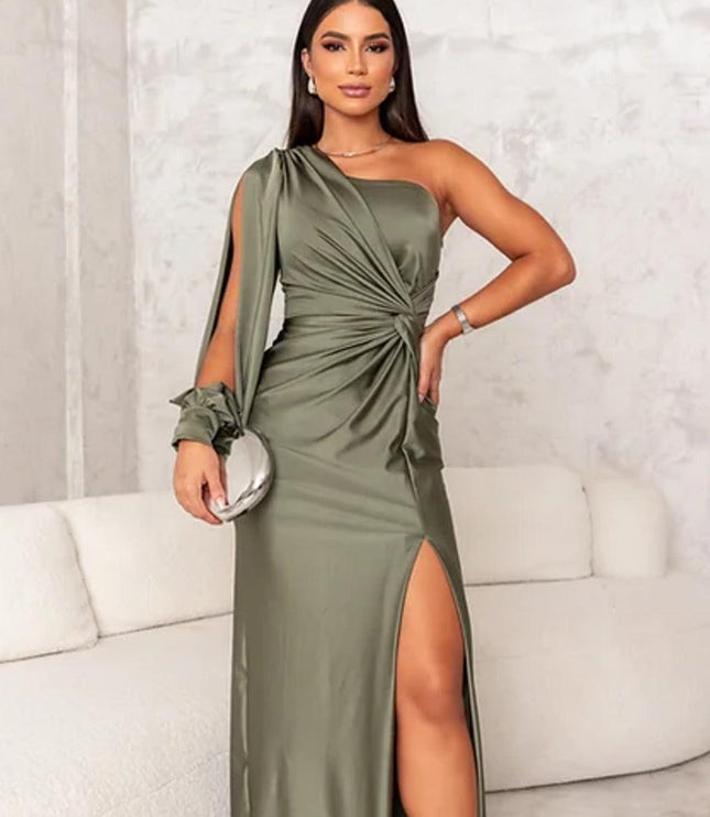 Front view of an olive green one shoulder ruched maxi dress, highlighting the high slit and flowing long sleeve detail.