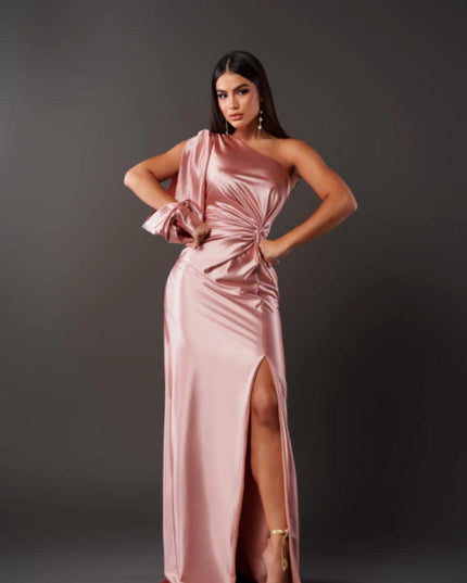 Light pink one shoulder ruched maxi dress with a high slit, showcasing the elegant satin fabric of the women's dress.