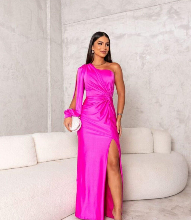 Bright fuchsia pink one shoulder ruched maxi dress with a high slit and long sleeve detail, a vibrant women's dress.