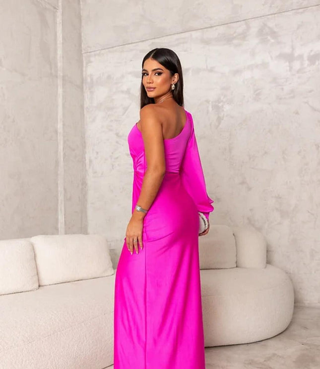 Back view of a vibrant fuchsia pink one shoulder maxi dress, highlighting the sleek fit and long sleeve of the women's dress.
