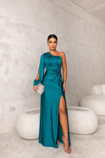 Full view of a women's teal one-shoulder ruched maxi dress with a thigh-high slit and long sleeve