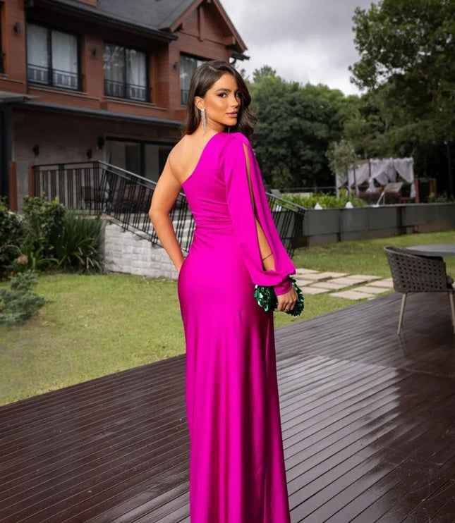 Back view of a fuchsia one-shoulder ruched maxi dress with a long sleeve, showing the smooth fabric.