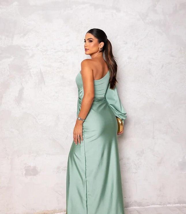 Back view of a women's light green one-shoulder maxi dress, highlighting the elegant drape of the fabric