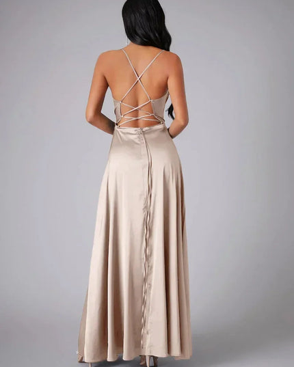 Back view of champagne satin cowl neck maxi dress with criss-cross spaghetti straps and a zipper closure.