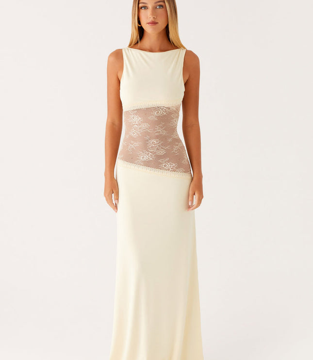 Front view of an ivory sleeveless maxi dress for women, featuring a boat neck and a sheer lace panel across the midsection.