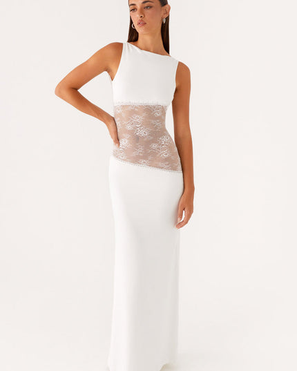 White sleeveless maxi dress with a high neckline and sophisticated lace cut-out details on the midsection, for a special occasion.